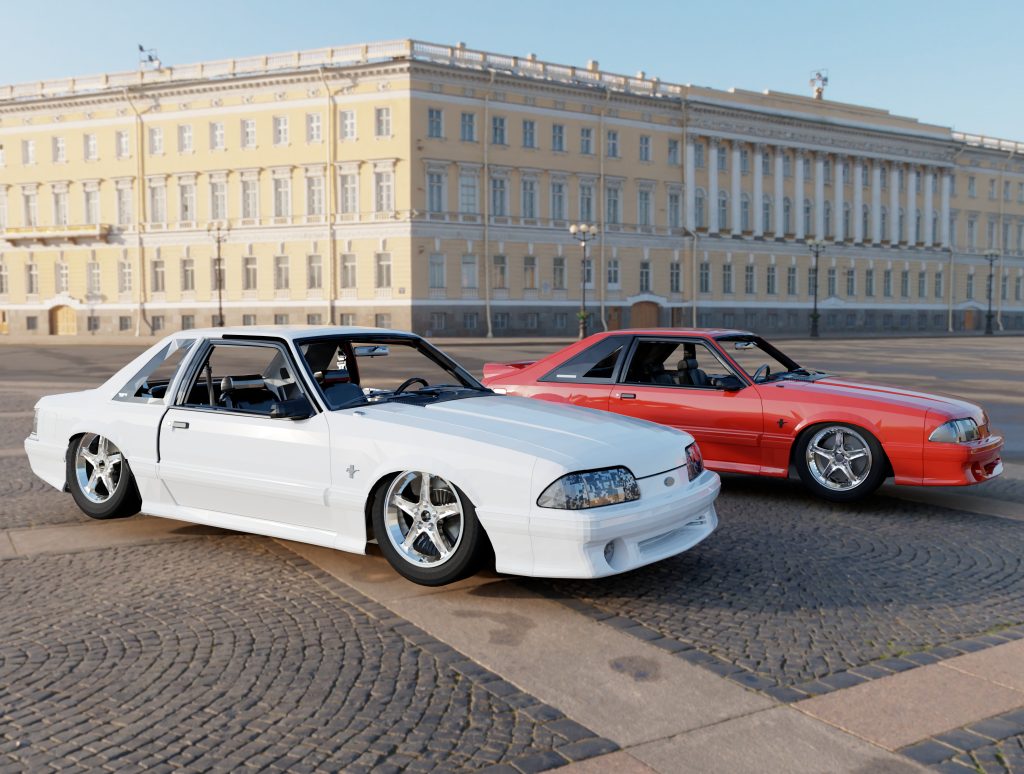 Two modified Ford Mustangs—one white, one red—parked on cobblestone in front of a grand classical building under clear skies