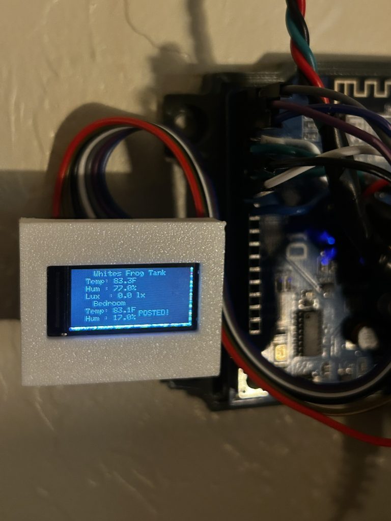An Arduino-based sensor system displays temperature and humidity readings for a frog tank and bedroom on an LCD screen mounted beside its circuit board