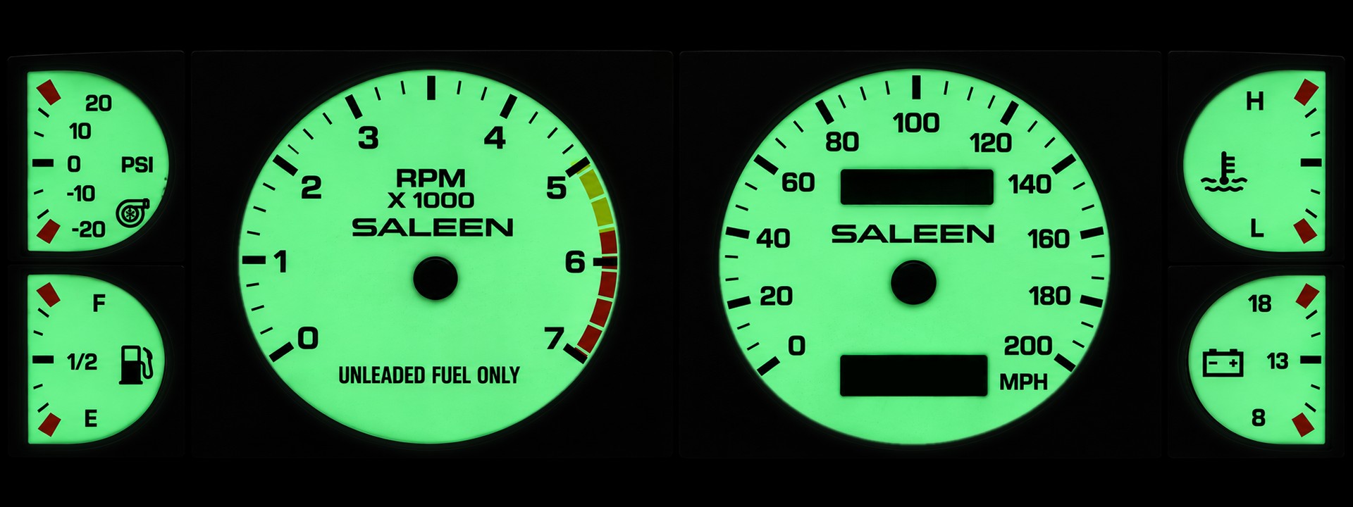 The Saleen white-face cluster lit bright green, with a boost gauge, tachometer, speedometer and small gauges
